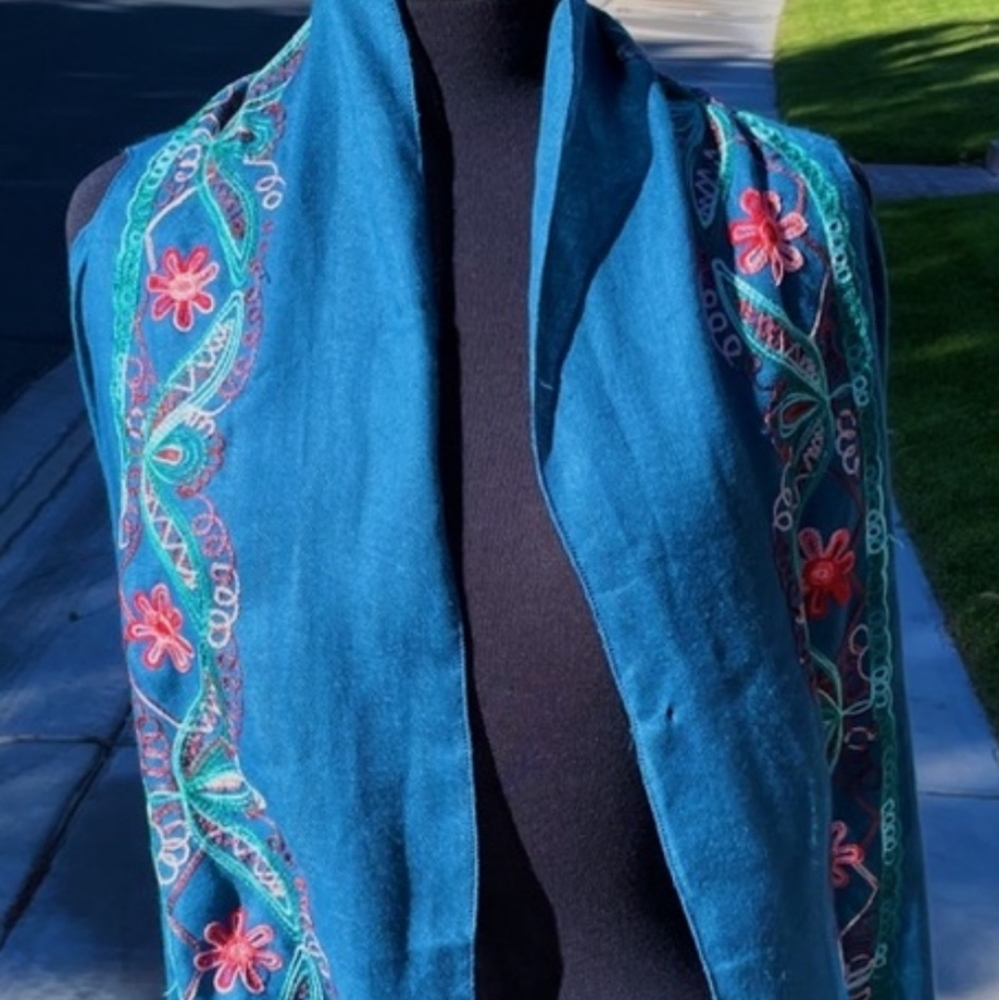 Long embroidered blue vest.